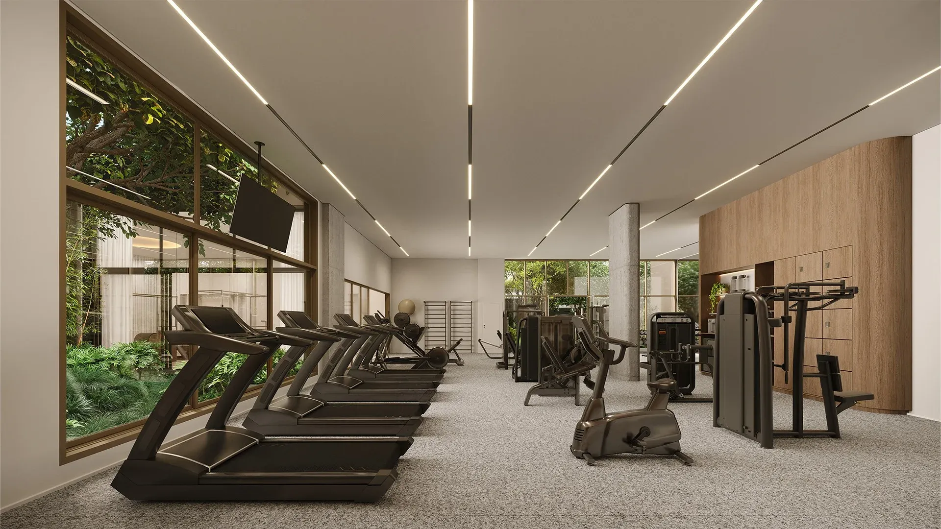Academia indoor no térreo do Alameda Mará em Moema, com esteiras, estações de musculação e janelas voltadas para o jardim.