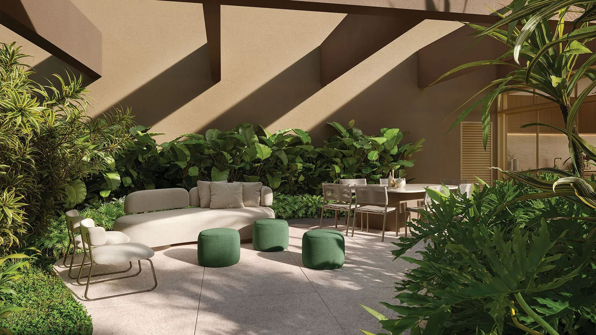 Lounge externo entre jardins no 1º pavimento do Alameda Mará, Gamaro, em Moema, com mesa de jantar externa e sofás verdes.